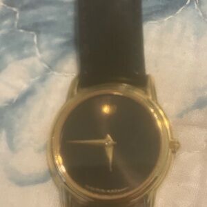 Movado Gold-Tone Case with Black Dial and Black Leather Strap. Needs battery.
